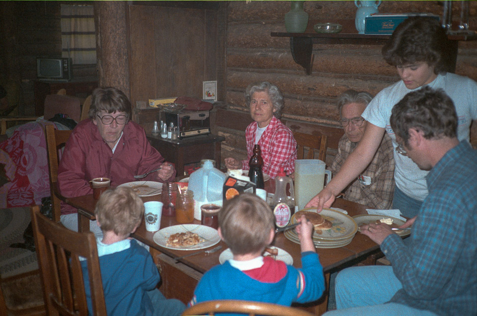 Breakfast at the Dining Room table: Clockwise from Mom - Elsie Jensen, Dad, Cara or Lara Coats, Doug, Jeff, and Brian